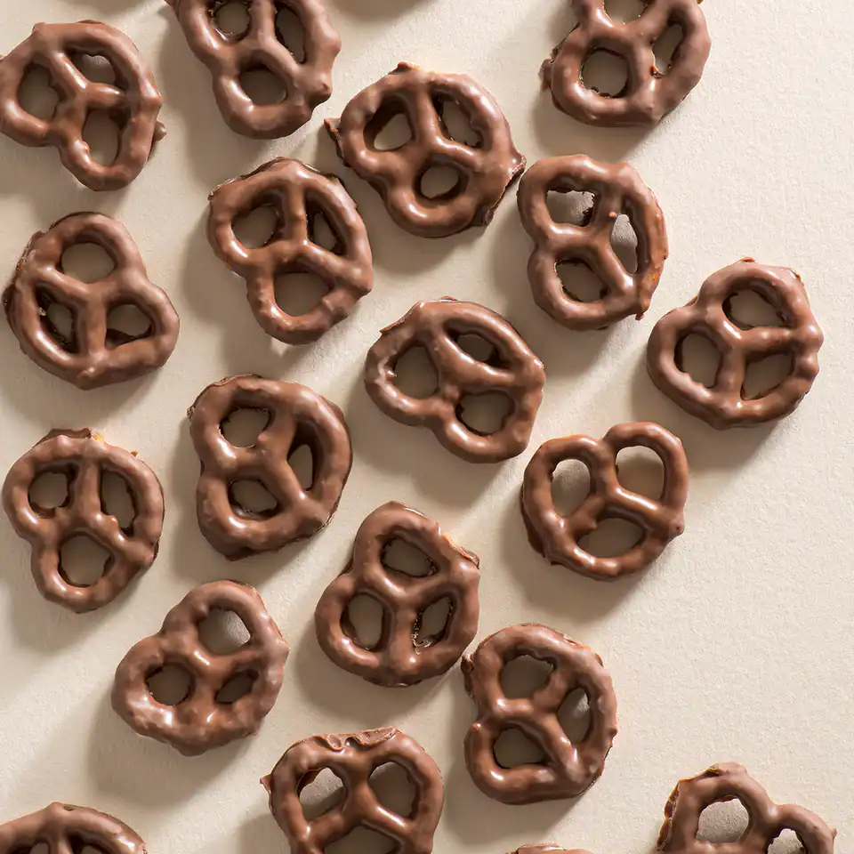MILK CHOC COATED PRETZELS 80G - New Farm Confectionery